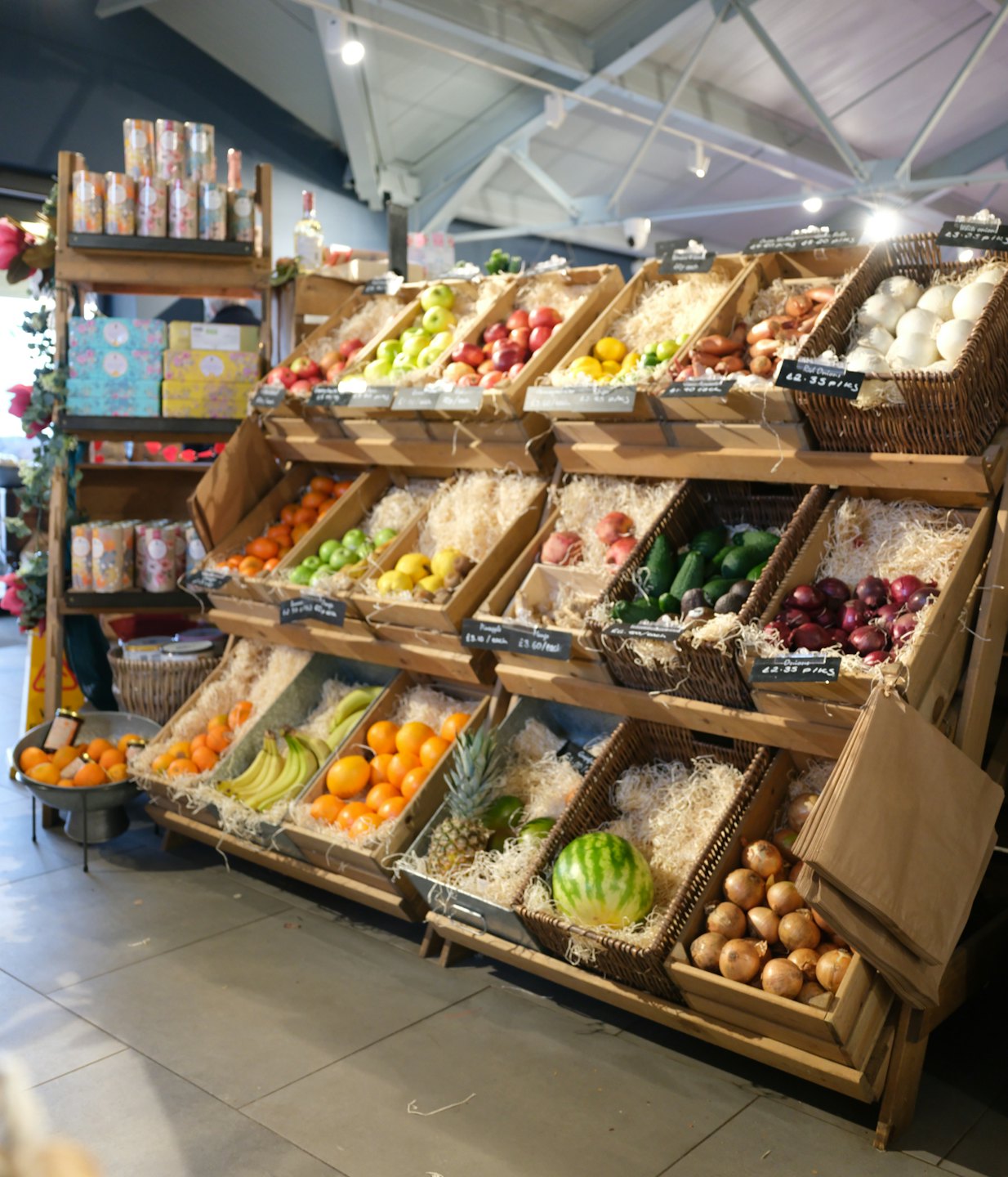 Fresh fruits and vegetables displayed in wooden crates and baskets.